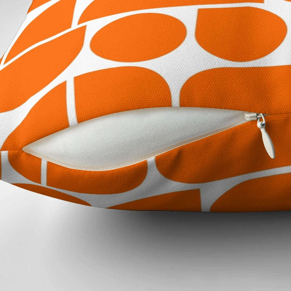 Vibrant orange throw pillow with abstract geometric shapes, inspired by mid-century modern and Scandinavian design.
