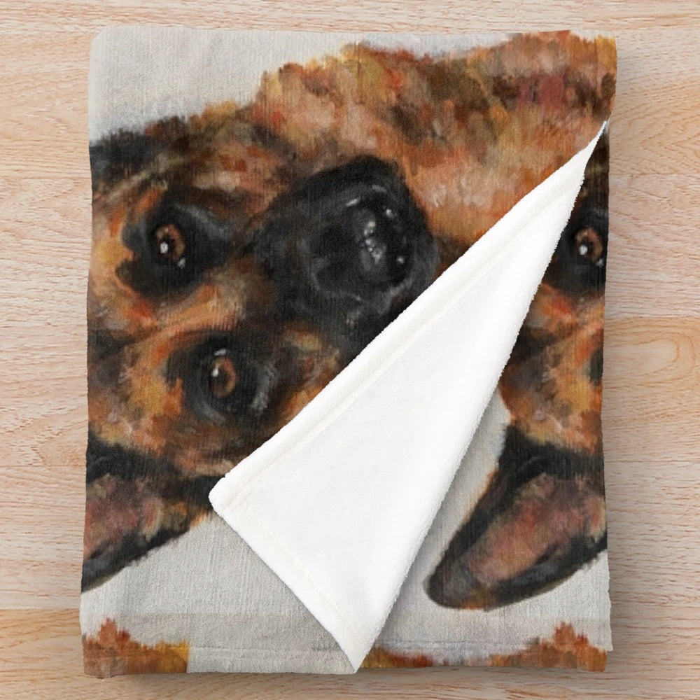 Colorful German Shepherd dog on a cozy autumn-themed plush blanket