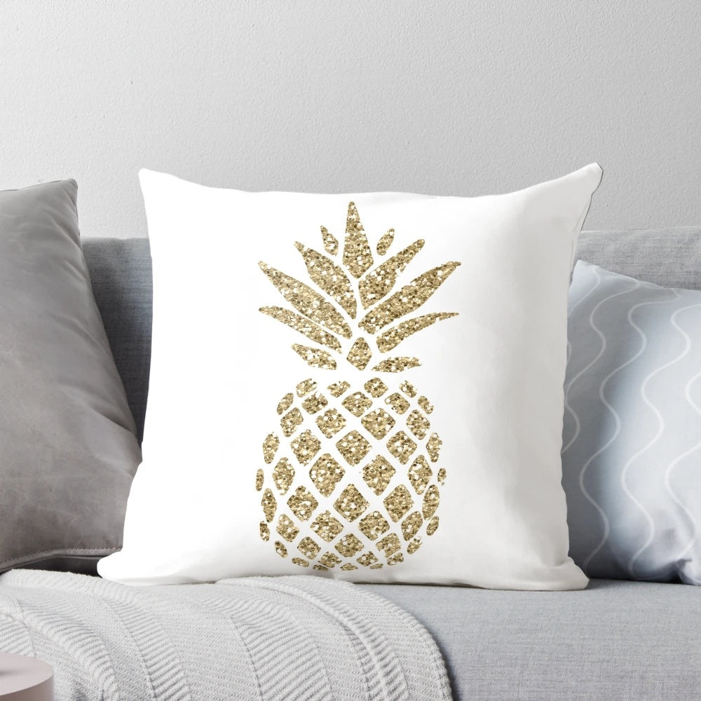 A plush, decorative pillow featuring a gold glittering pineapple design in a watercolor-inspired, colorful splash pattern.