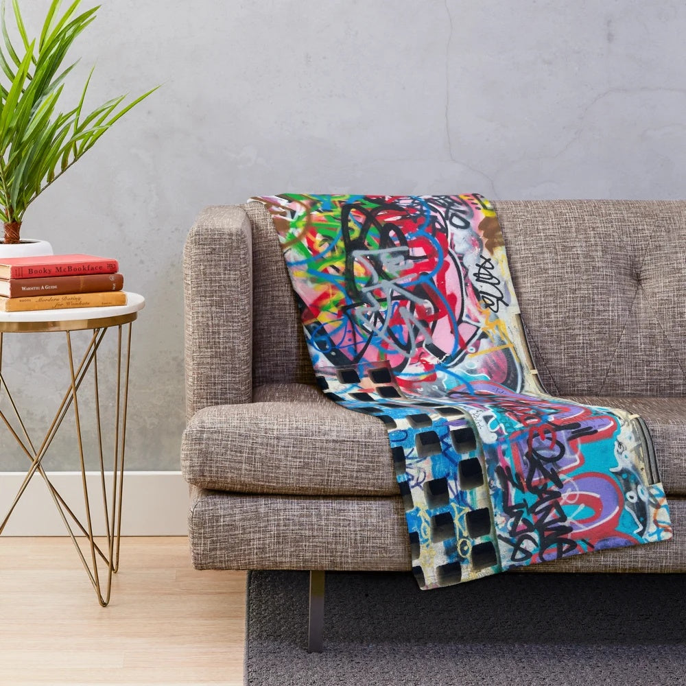 Graffiti-style plush blanket featuring a cinema building design