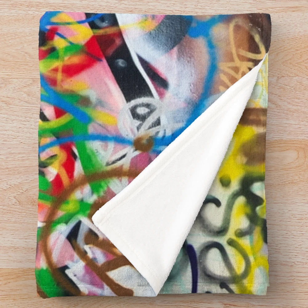 Graffiti-style plush blanket featuring a cinema building design
