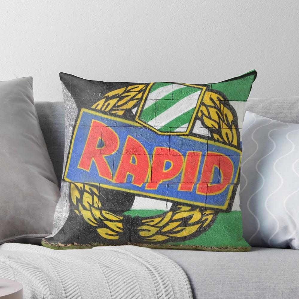 Colorful graffiti-style pillow featuring the Rapid Wien soccer club logo and fans' "Rapid ist meine religion" slogan.