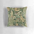 Decorative pillow featuring a vibrant green forest scene with peacocks, foxes, and hares surrounded by lush botanical prints and floral patterns.