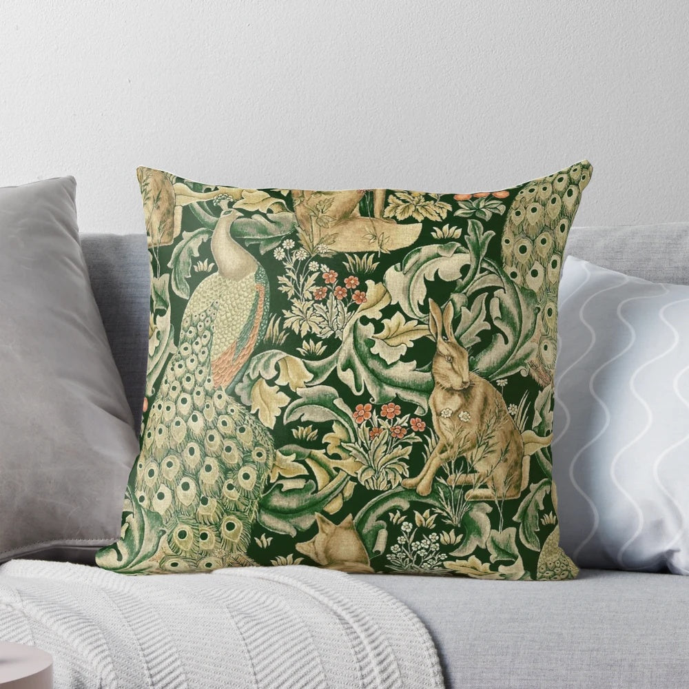 Decorative pillow featuring a vibrant green forest scene with peacocks, foxes, and hares surrounded by lush botanical prints and floral patterns.