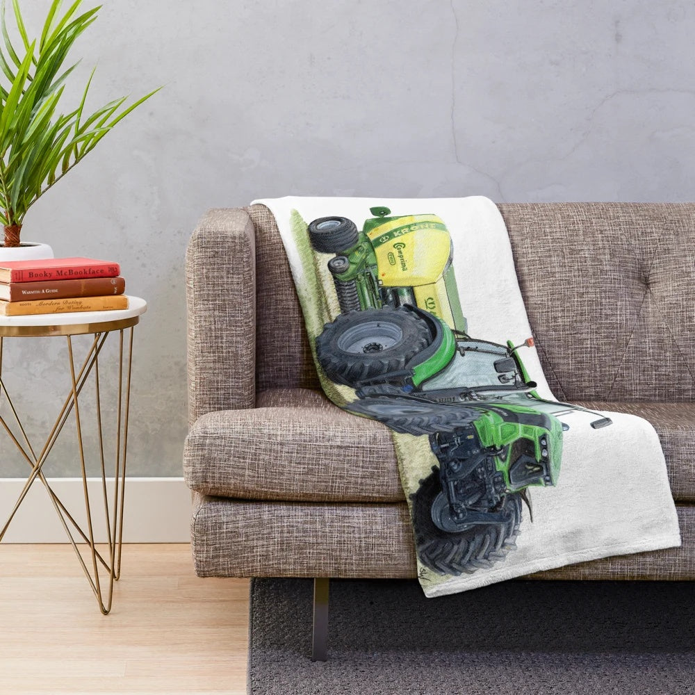Tractor plush blanket featuring a vivid green tractor painting