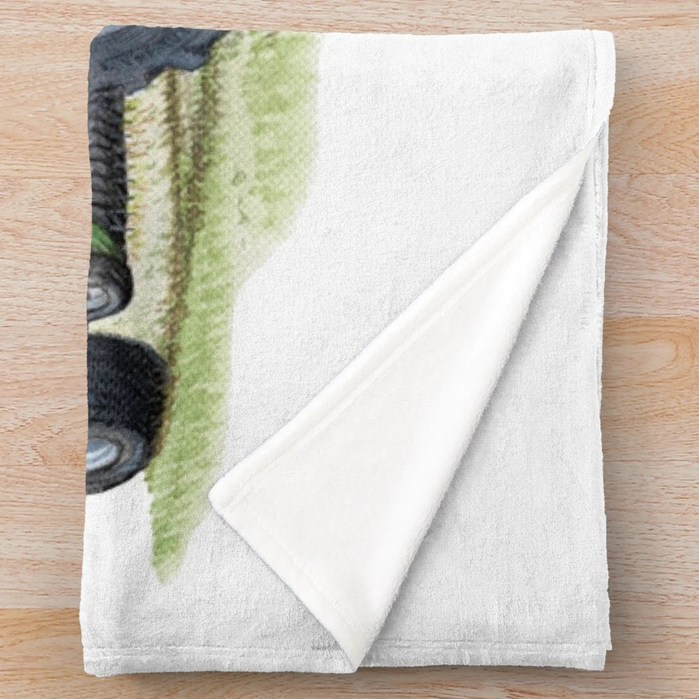 Tractor plush blanket featuring a vivid green tractor painting