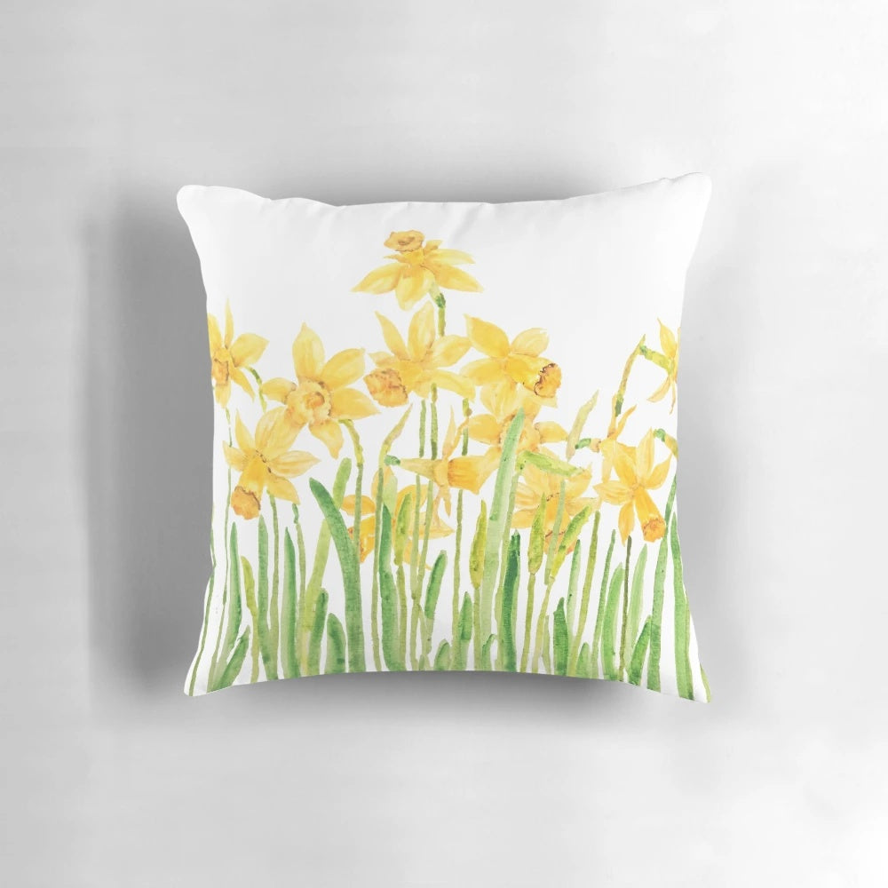 Colorful hand painted daffodil flowers in a meadow watercolor design on a square throw pillow.