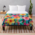 Colorful Hawaiian hibiscus floral pattern plush blanket with bright tropical stripes