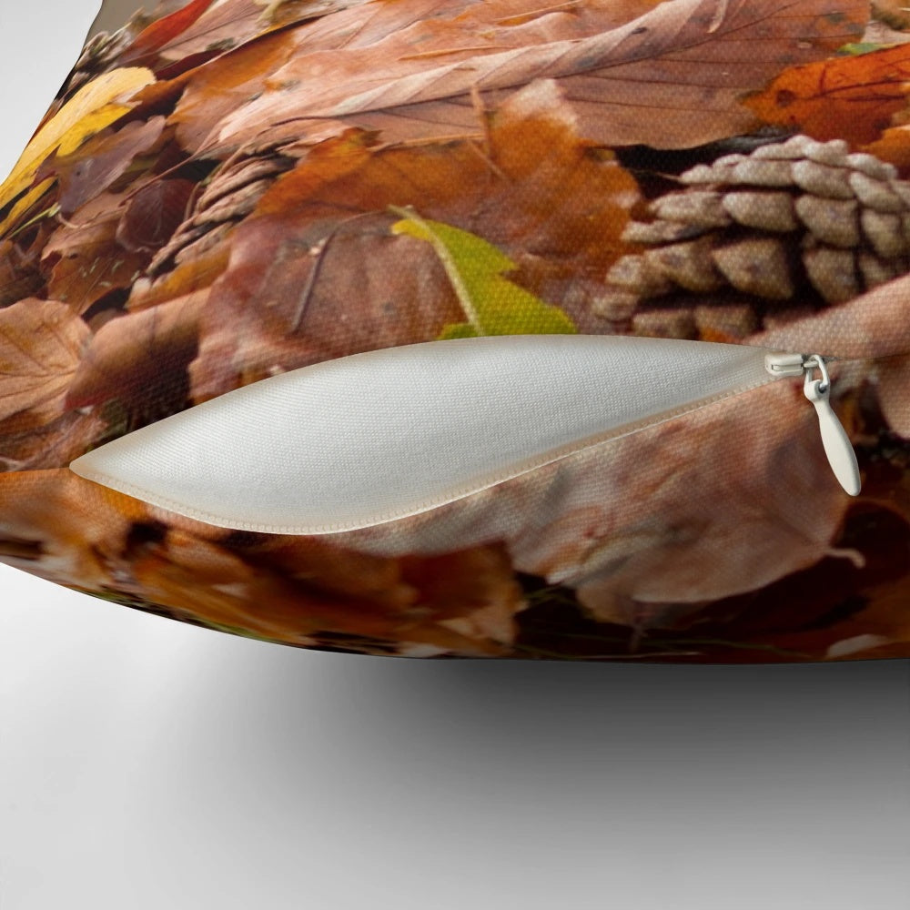 Red squirrel nestled in autumnal leaves on a pillow