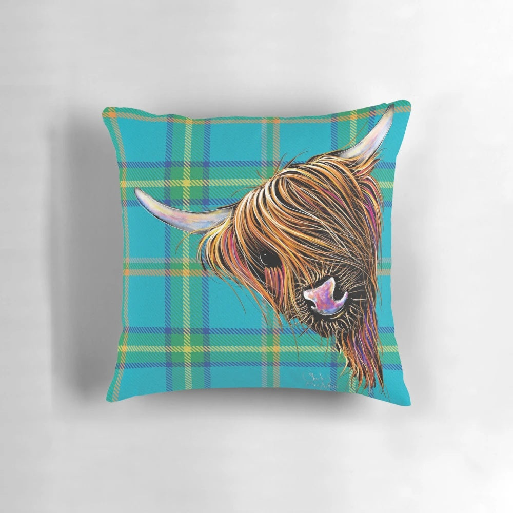 Colorful and cozy decorative pillow featuring a friendly highland cow against a tartan pattern background.
