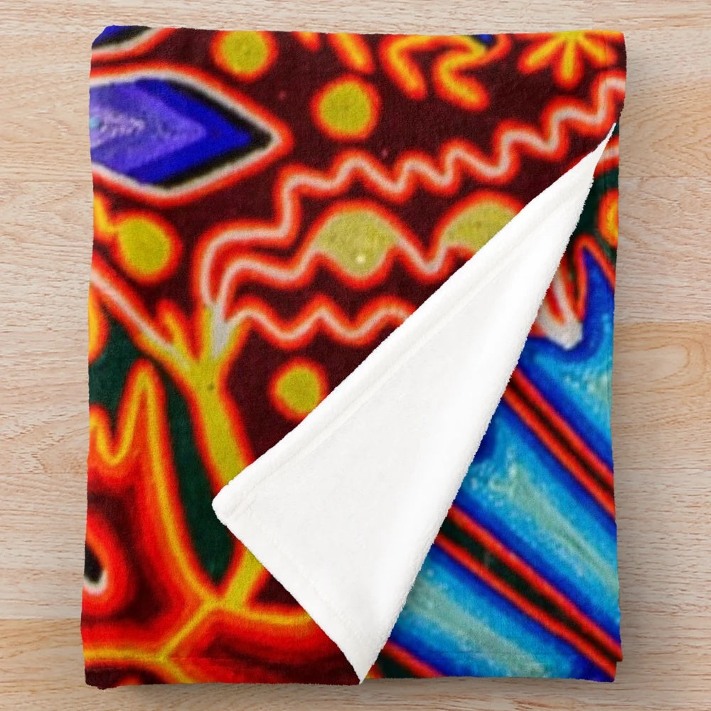 Colorful plush blanket with traditional Huichol textile design