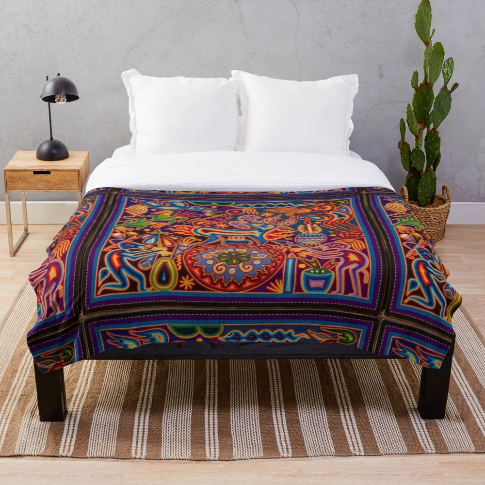 Colorful Huichol-inspired plush blanket with abstract skull and floral patterns