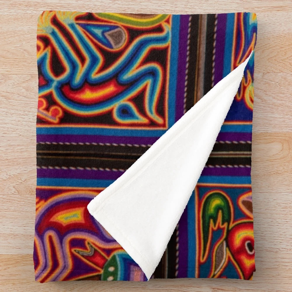 Colorful Huichol-inspired plush blanket with abstract skull and floral patterns