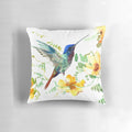 A vibrant watercolor painting of a hummingbird hovering above tropical flowers on a decorative accent pillow.