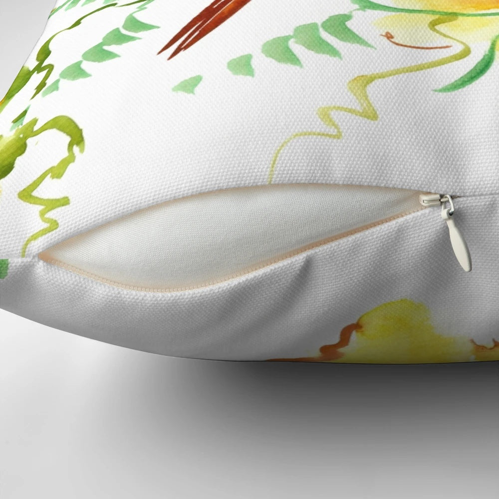 A vibrant watercolor painting of a hummingbird hovering above tropical flowers on a decorative accent pillow.