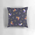 Colorful pillow featuring a geometric, floral design with hummingbirds in a tropical paradise