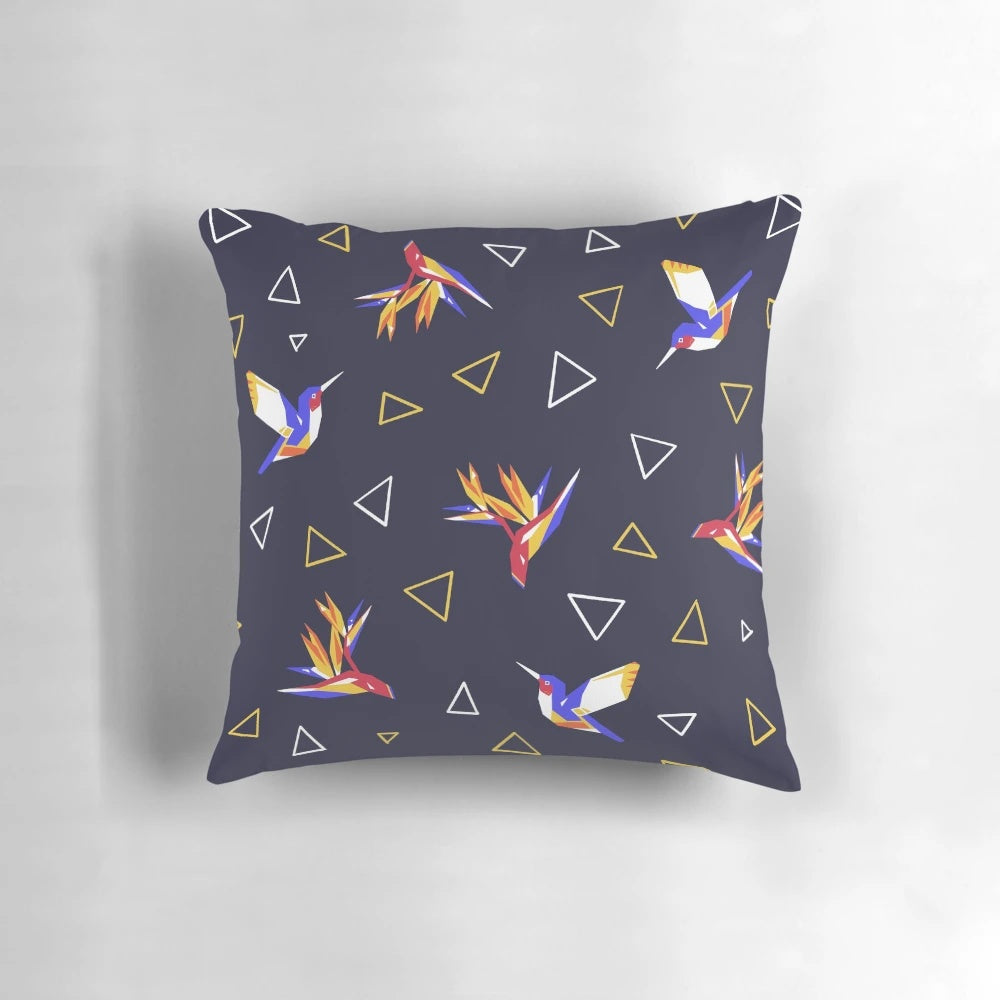 Colorful pillow featuring a geometric, floral design with hummingbirds in a tropical paradise