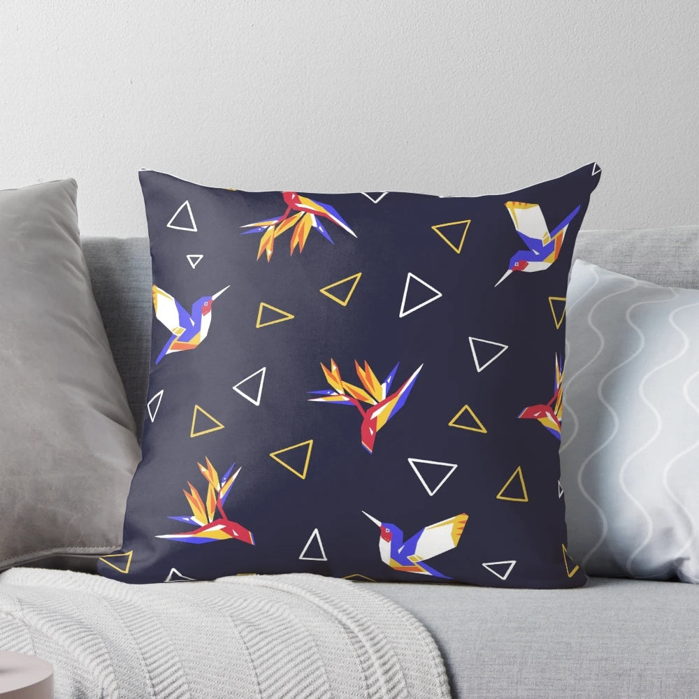 Colorful pillow featuring a geometric, floral design with hummingbirds in a tropical paradise