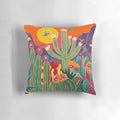 A decorative throw pillow featuring a hummingbird perched on a cactus, set against a vibrant desert landscape.