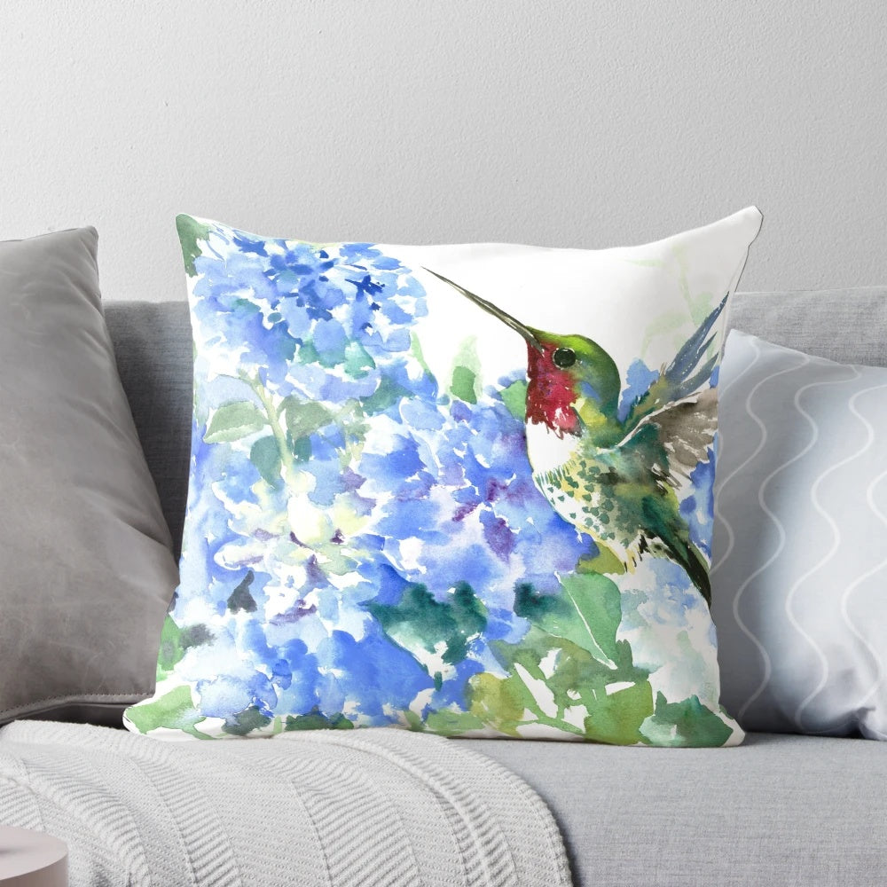 Colorful watercolor painting of a hummingbird hovering over vibrant hydrangea flowers in shades of blue.
