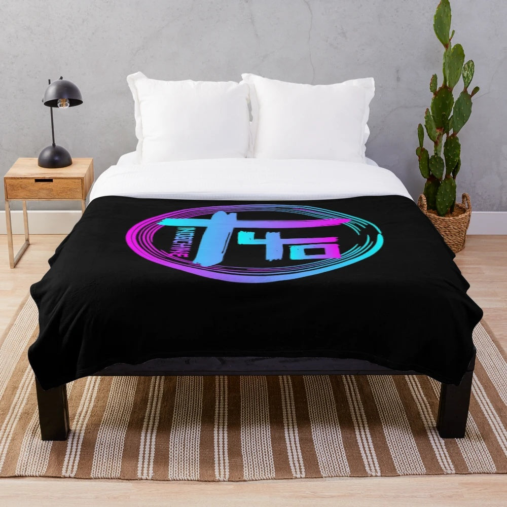 Colourful Indochine-inspired plush blanket with band logo