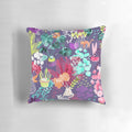 A colorful and modern pillow featuring a watercolor-style illustration of indoor plants, kittens, and a geometric design in shades of teal, pink, purple, and green.