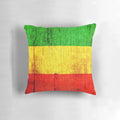 Colorful psychedelic pillow with Jamaican flag-inspired green, gold, and red abstract pattern