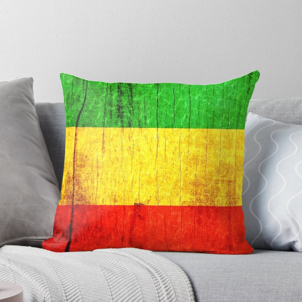 Colorful psychedelic pillow with Jamaican flag-inspired green, gold, and red abstract pattern