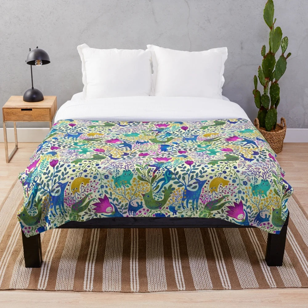 Colorful plush blanket with vibrant floral and animal pattern