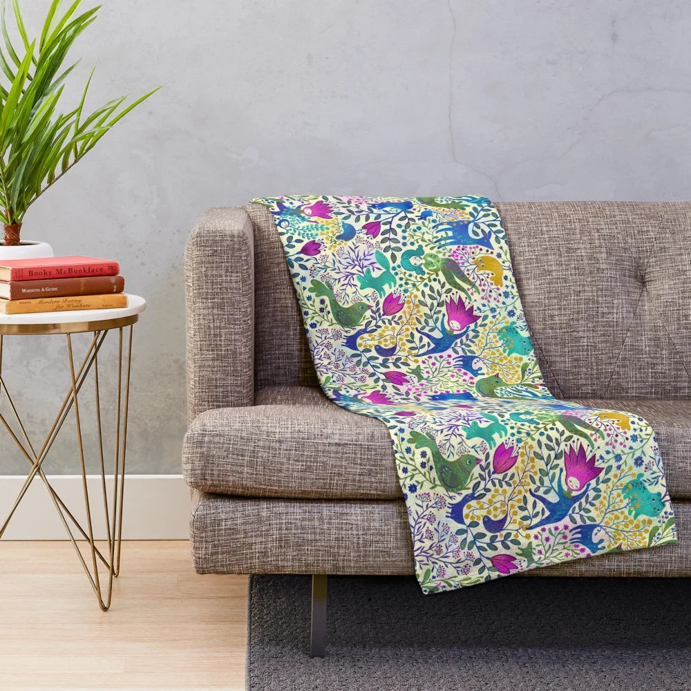 Colorful plush blanket with vibrant floral and animal pattern