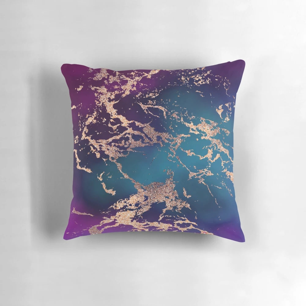 Vibrant jewel tone rose gold marble pillow in shades of turquoise, blue, and purple
