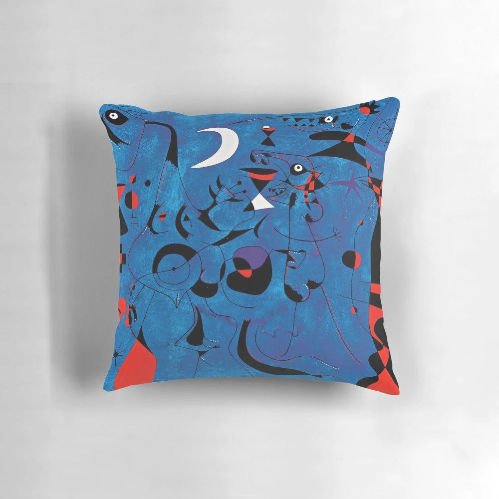 A decorative pillow featuring abstract blue and red geometric shapes inspired by the artwork of renowned surrealist painter Joan Miro.