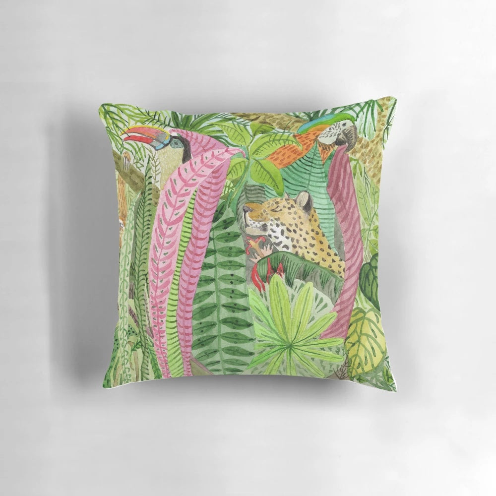Lush jungle-inspired pillow with botanical leaves, flowers, and animal prints
