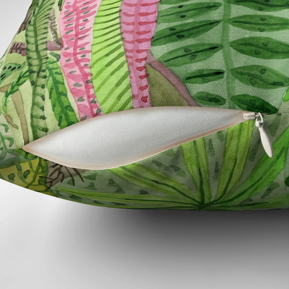 Lush jungle-inspired pillow with botanical leaves, flowers, and animal prints