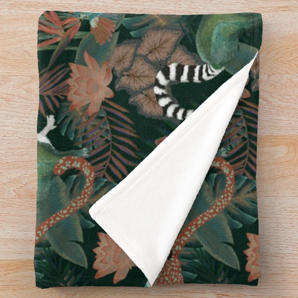 Plush jungle-themed blanket with tropical wildlife, botanical prints, and vibrant colors