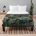 Colorful plush blanket featuring a jungle pattern with toucans, flamingos, and parrots