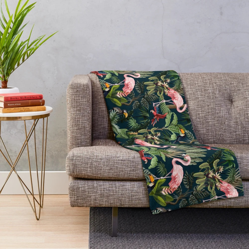 Colorful plush blanket featuring a jungle pattern with toucans, flamingos, and parrots
