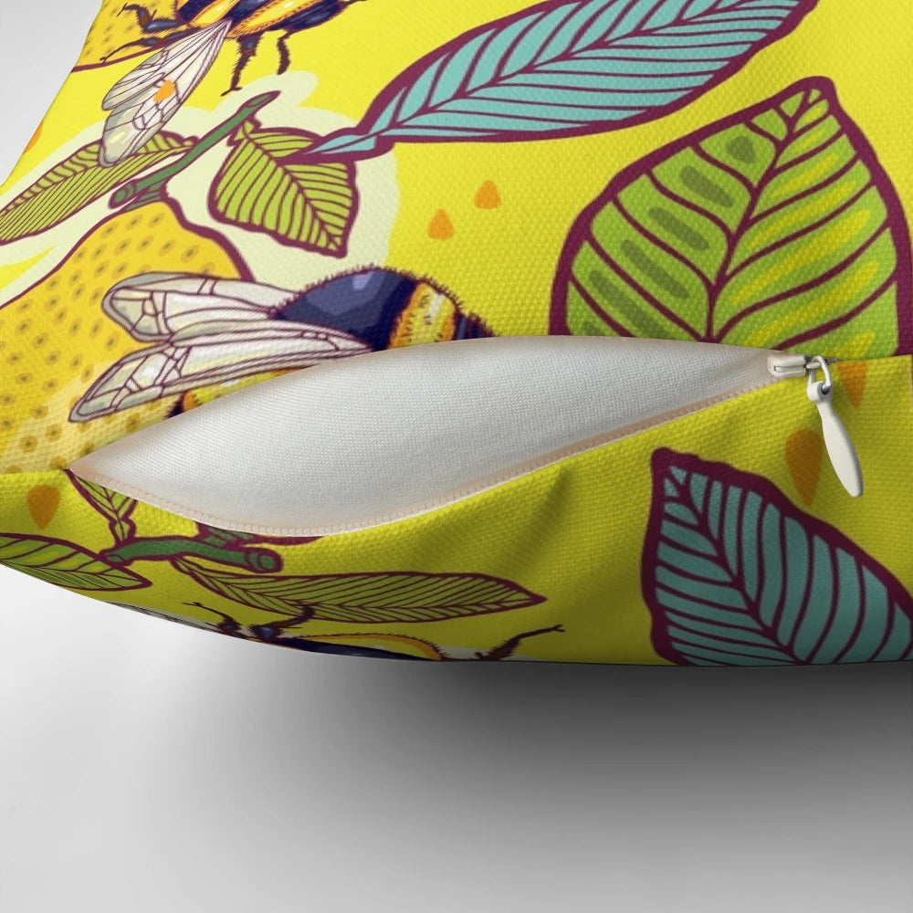 Colorful pillow with a design featuring a lemon, bees, and a garden scene