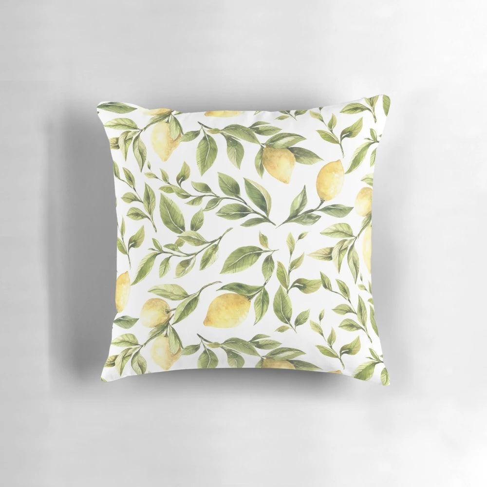 Colorful pillow featuring a summer pattern with yellow lemons, green leaves, and a botanical design.