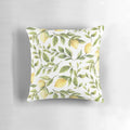 Colorful pillow featuring a summer pattern with yellow lemons, green leaves, and a botanical design.