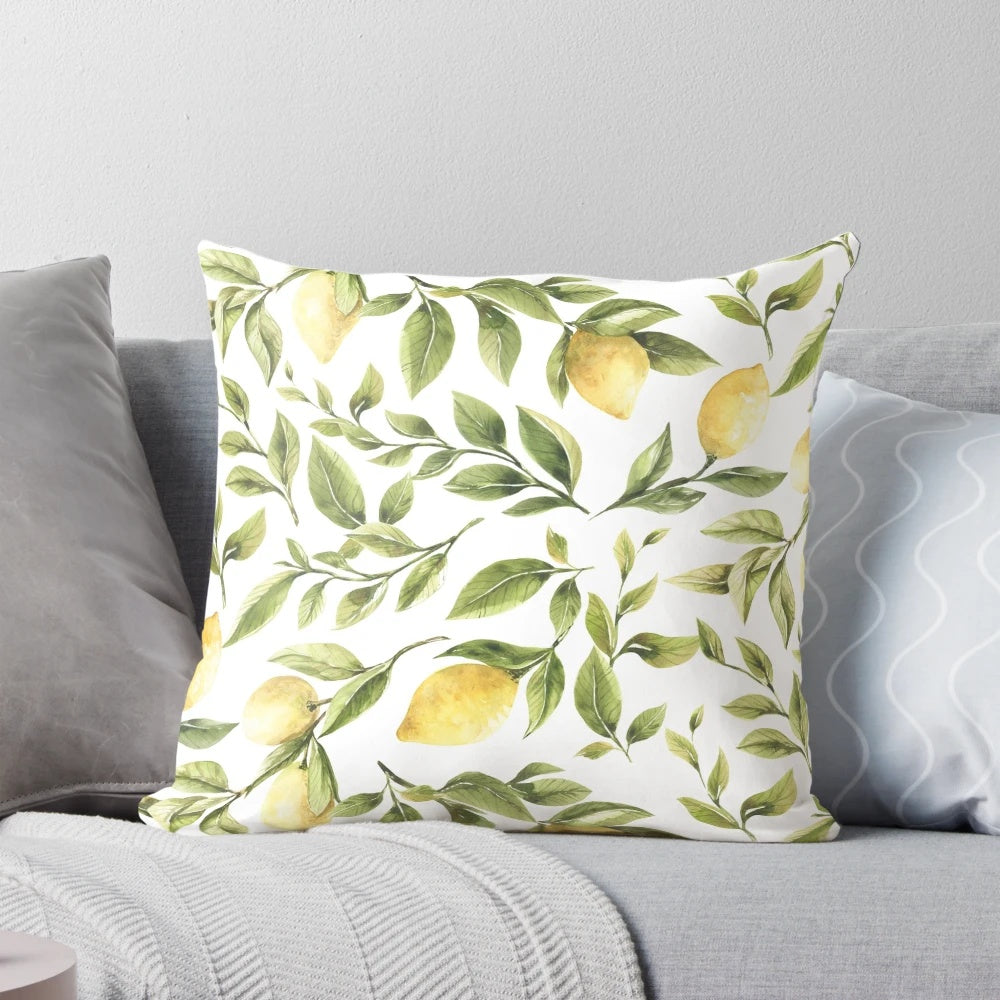 Colorful pillow featuring a summer pattern with yellow lemons, green leaves, and a botanical design.