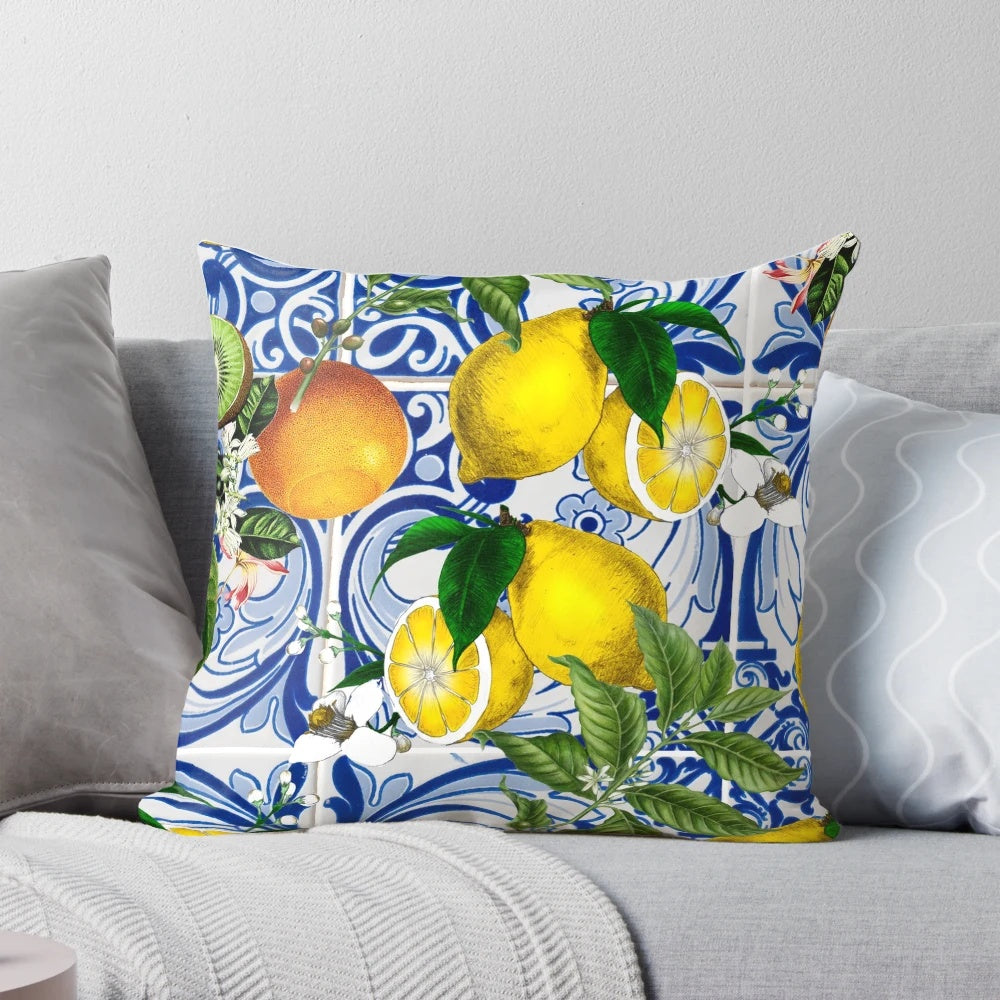 Colorful Mediterranean-inspired pillow with a lemon pattern print against a blue background.