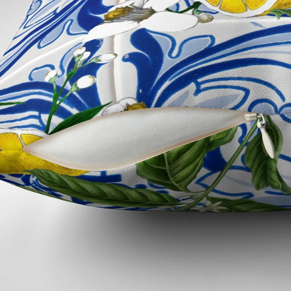 Colorful Mediterranean-inspired pillow with a lemon pattern print against a blue background.
