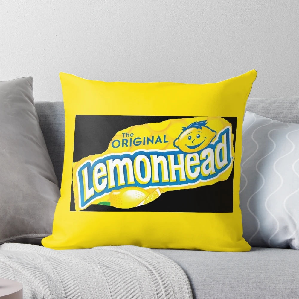 Colorful pillow featuring the iconic Lemonhead candy design, perfect for adding a touch of humor and sweetness to any room.