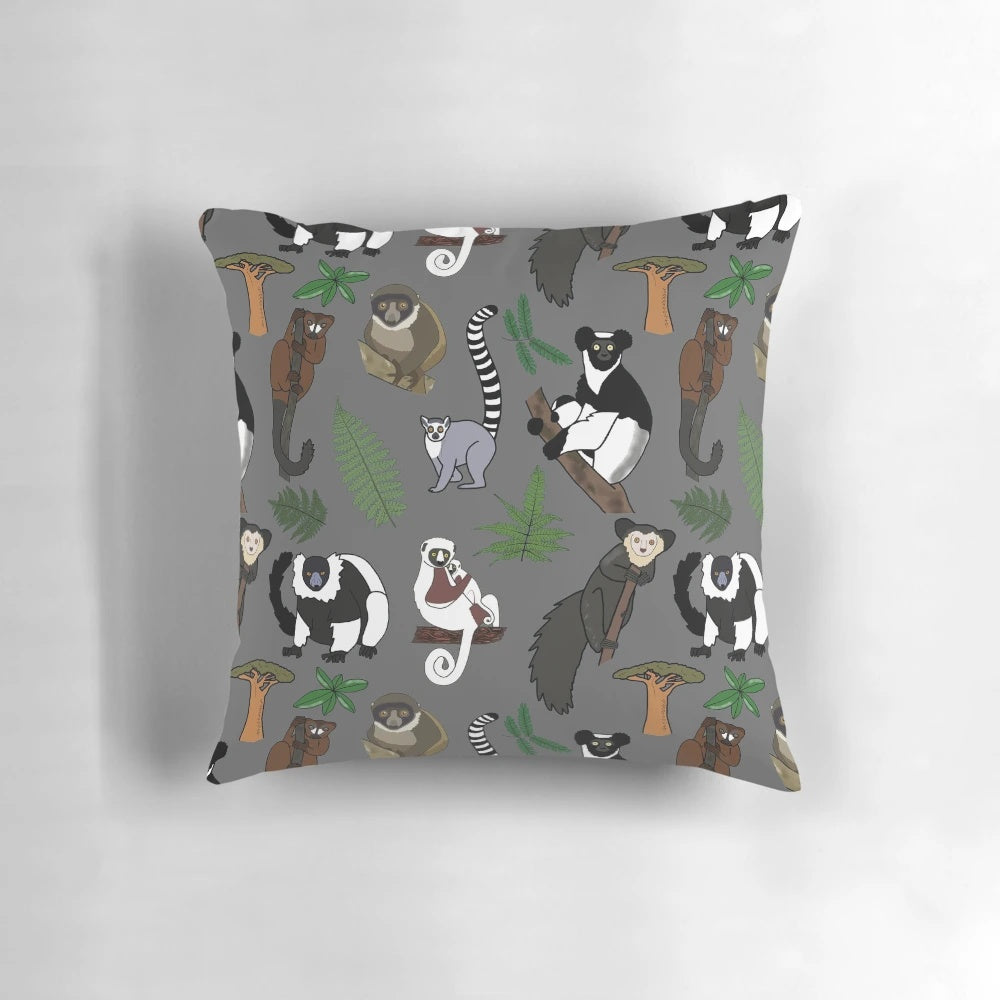 Colorful pillow featuring a repeating pattern of various lemur species native to Madagascar