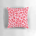 Closeup of a vibrant leopard print pillow in shades of red and pink.