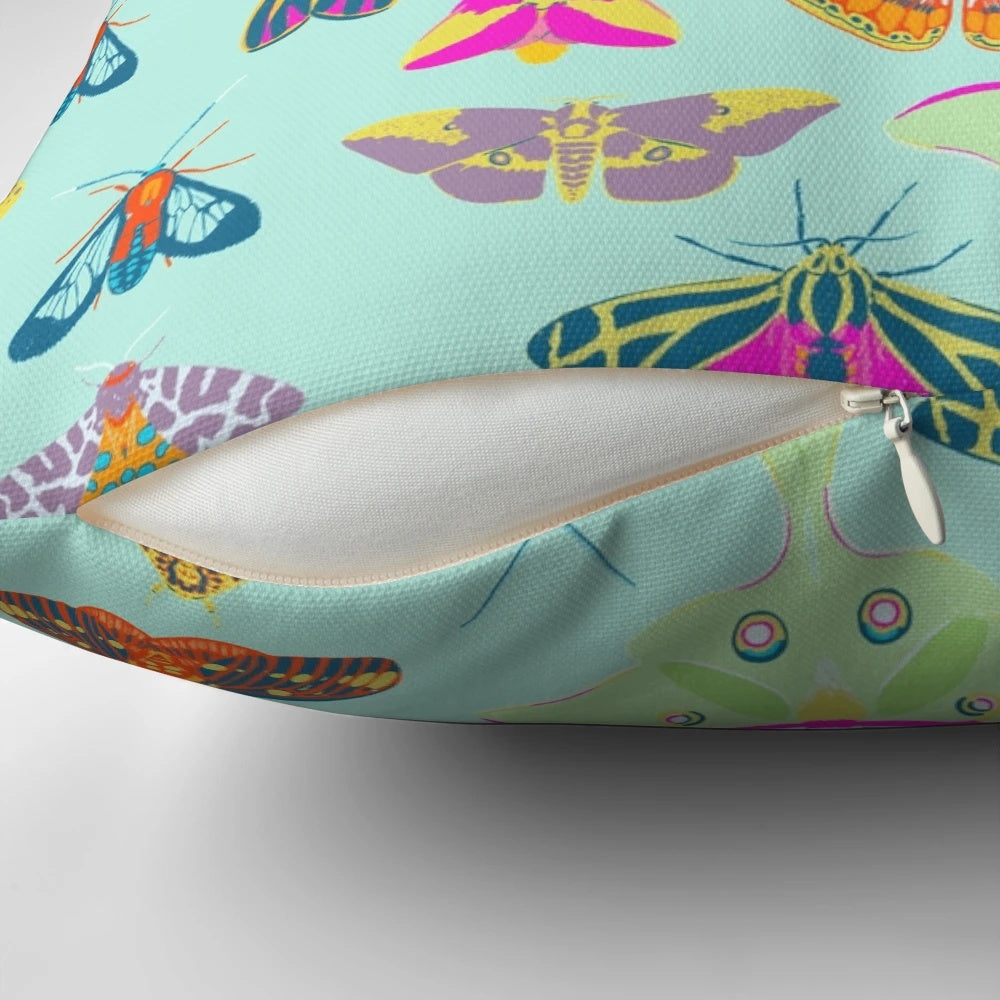 Colorful pillow featuring a variety of moths and butterflies in a nature-inspired surface design.
