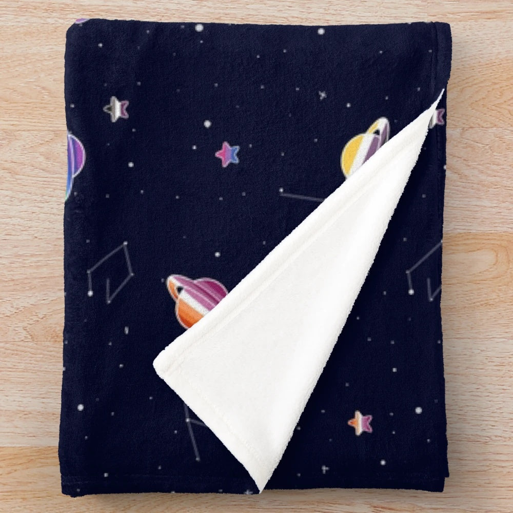 Colorful LGBTQ pride plush blanket with space pattern of planets, stars, and constellations