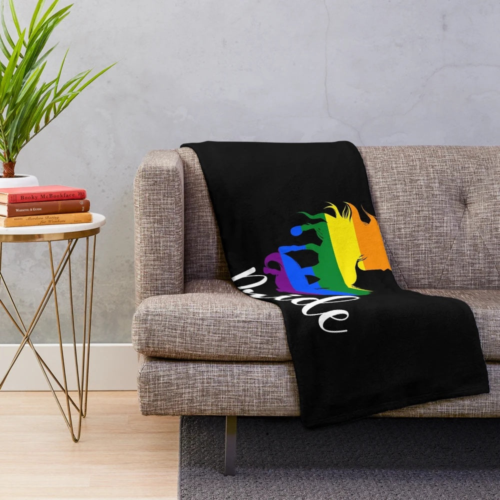 Colorful plush blanket featuring a unicorn in rainbow flag colors