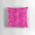 Closeup of a vibrant magenta and pink abstract pattern pillow with fluid, swirling shapes and circles.